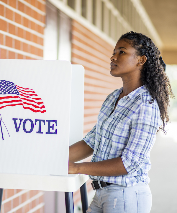 student at voting booth