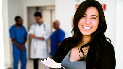 student carrying books with backdrop of medical instructors