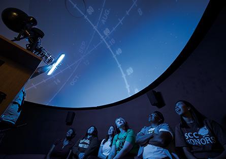 Students observing a presentation in the SCC Planetarium