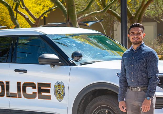 police officer standing in front of vehicle