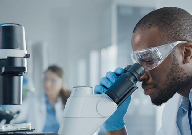 student looking through microscope